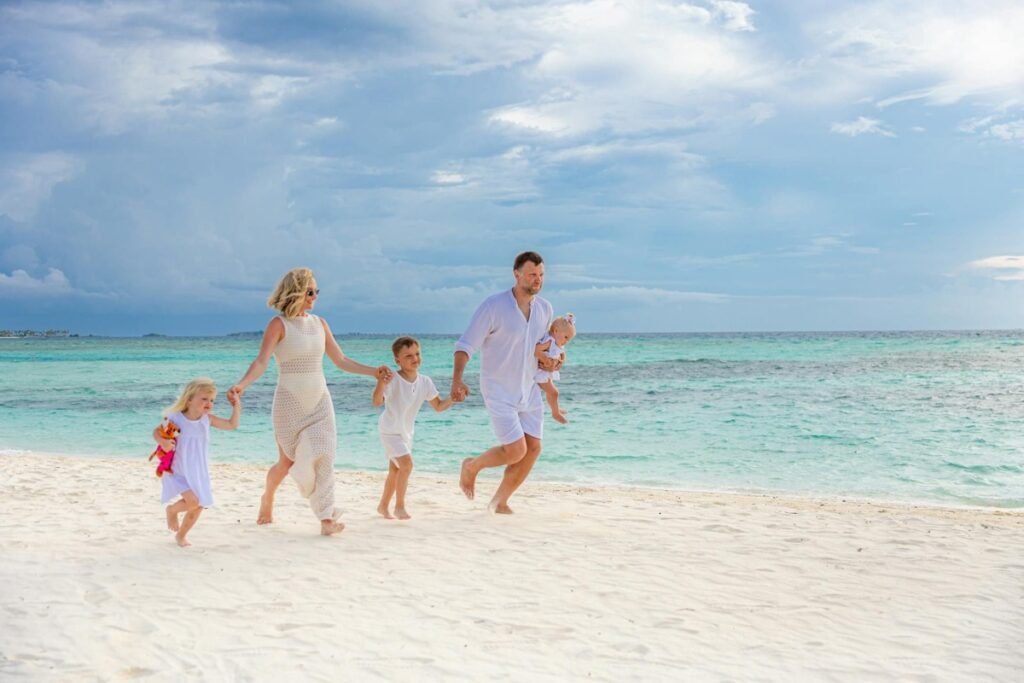 Family enjoying a luxury beach holiday by the ocean
